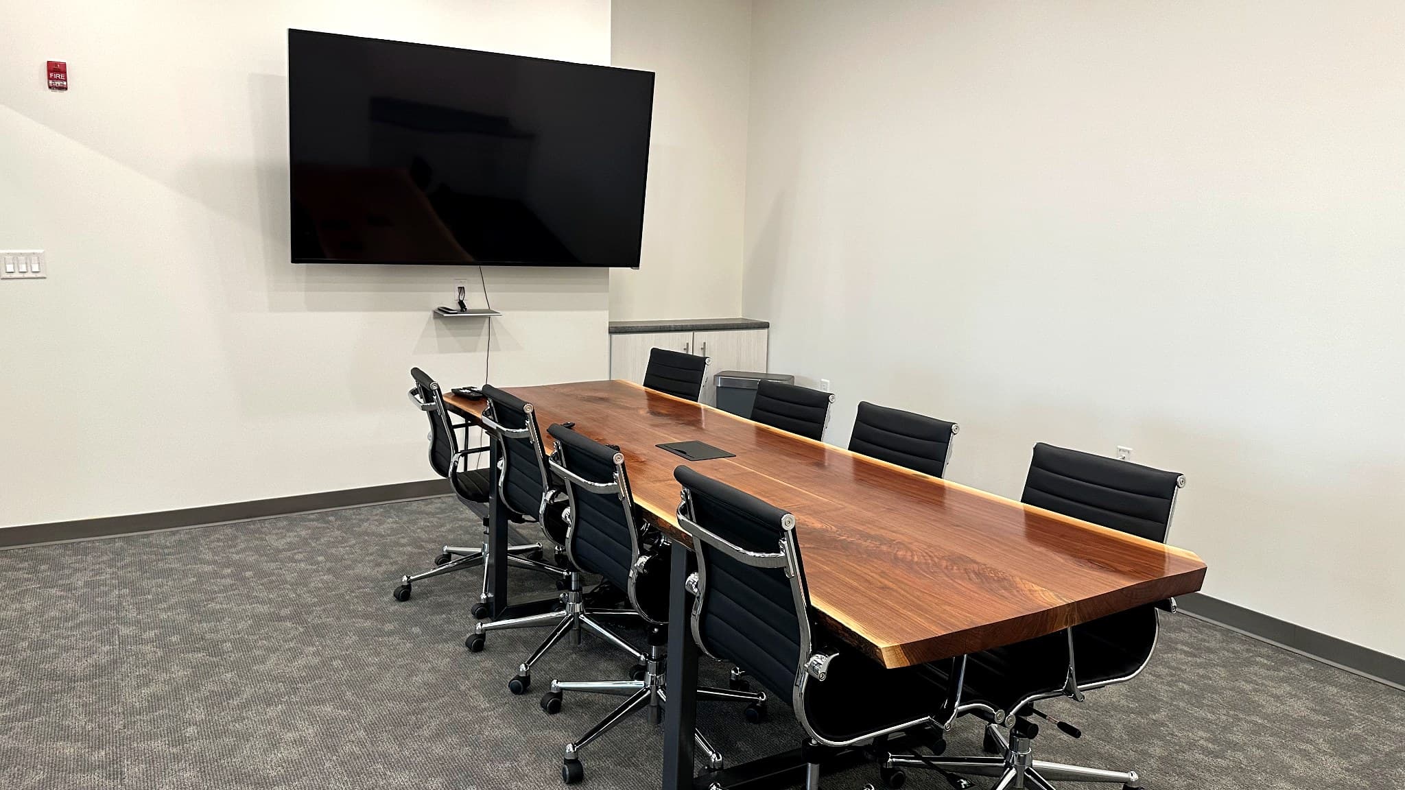 Live-edge walnut boardroom at Murray Place Suites in Peoria