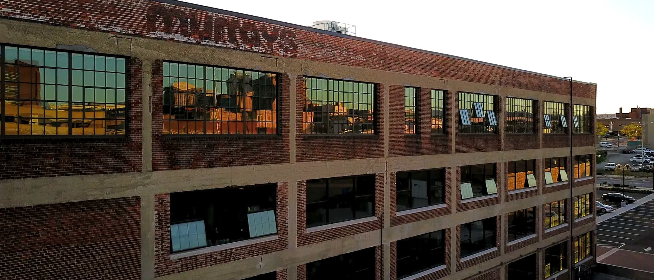 Exposed brick and factory windows inside Murray Place Suites